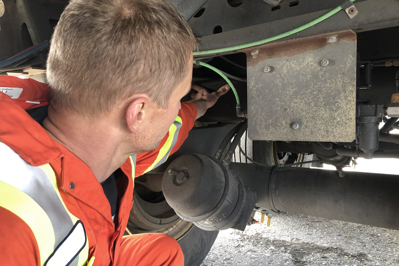 Man inspecting vehicle's suspension system